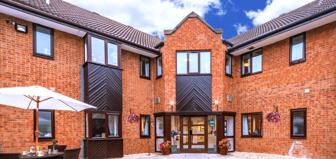 Modern brick building with pitched roofs and patio umbrellas