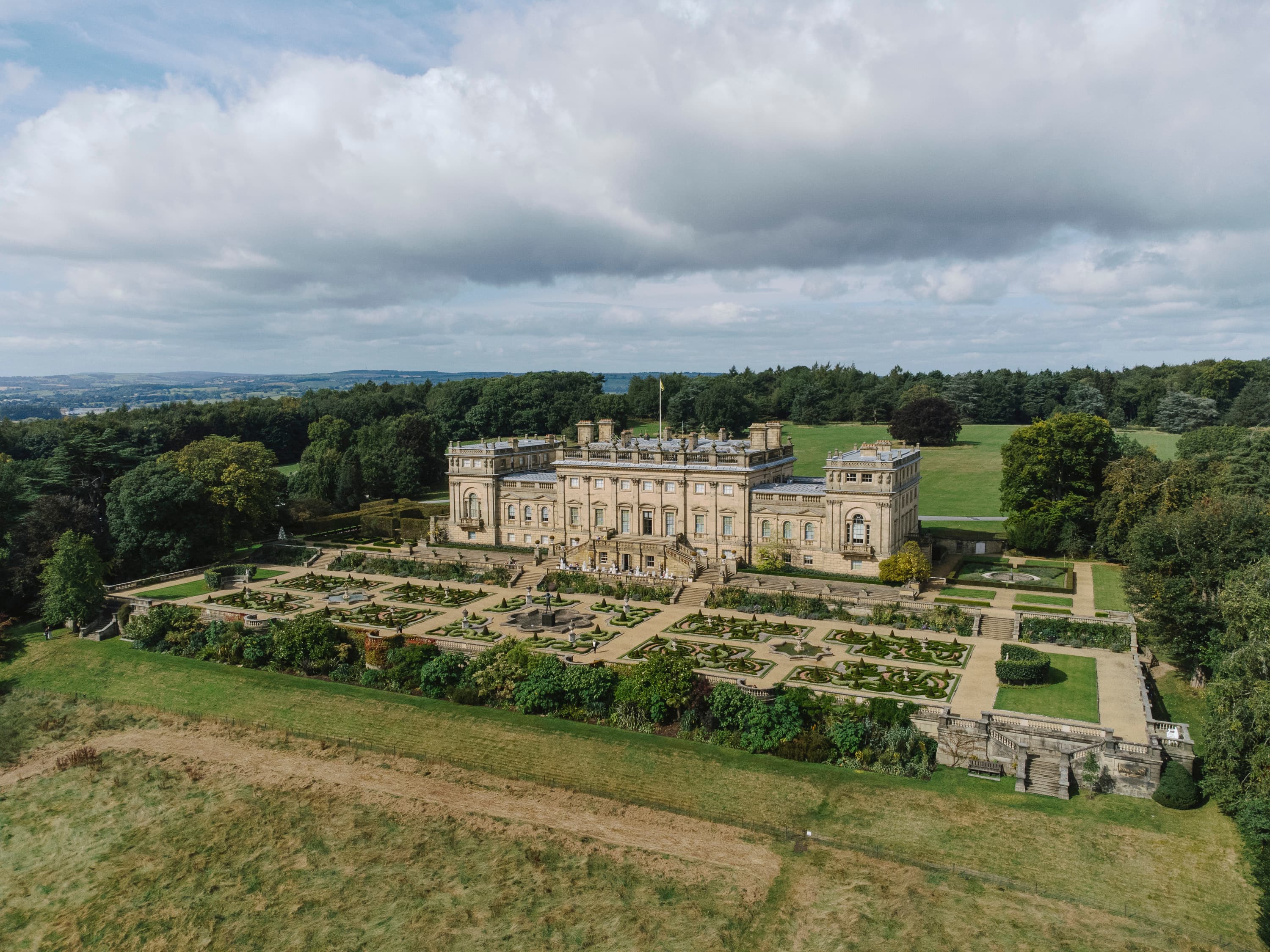 Historic stone mansion with formal gardens and expansive lawns