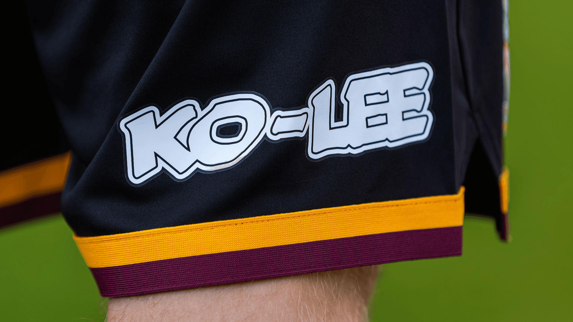 Close-up of black sports shorts with sponsor logo