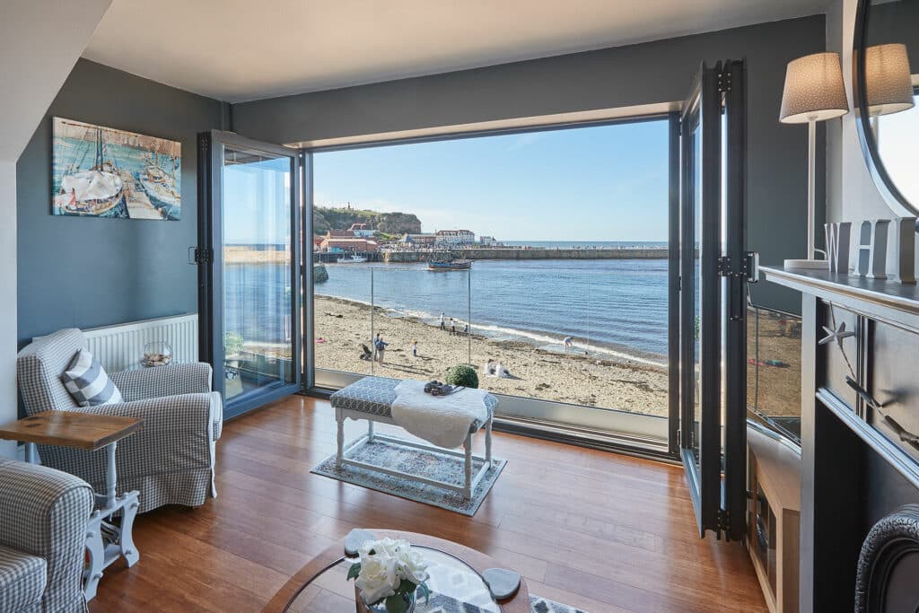 Cozy living room with large window view of Whitby beach