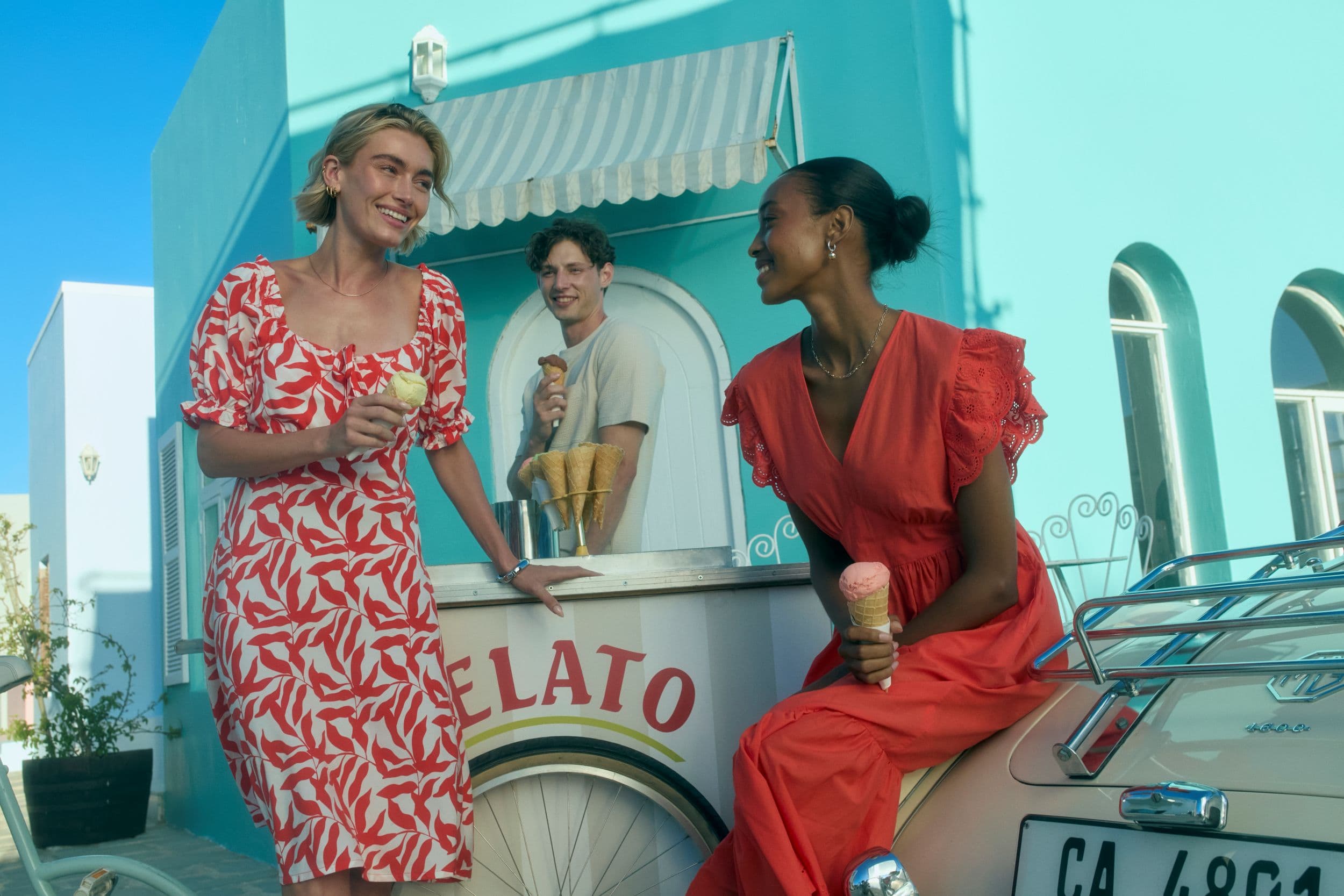 Three people enjoying ice cream by a vintage gelato cart