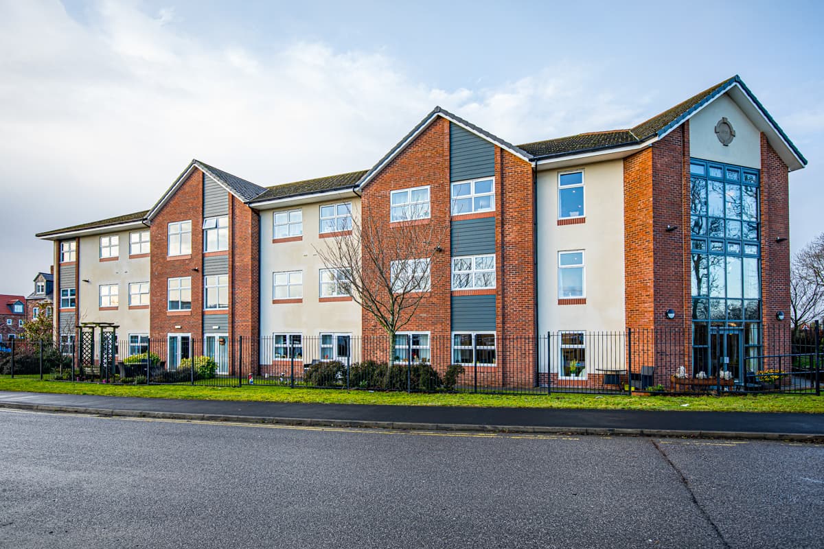 Hambleton Grange Care Home in Thirsk: Modern red-brick building with large windows and garden view