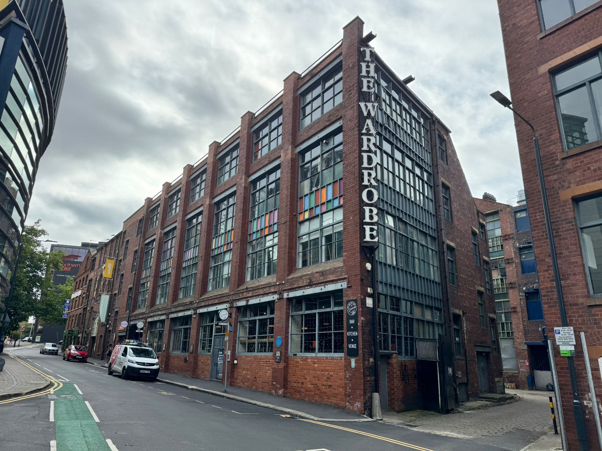 Red brick industrial building with large glass windows