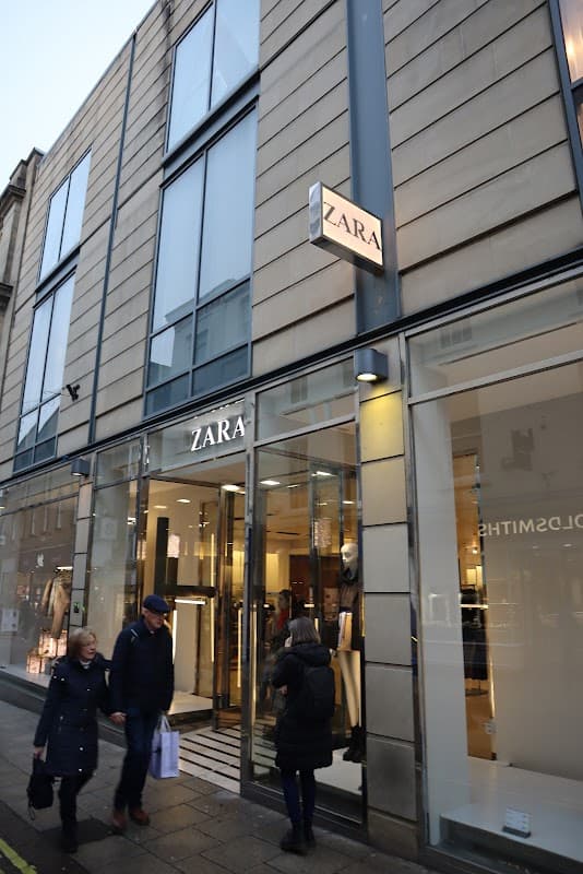 ZARA storefront in Brightside, Yorkshire, with shoppers entering and exiting, showcasing a modern glass facade.