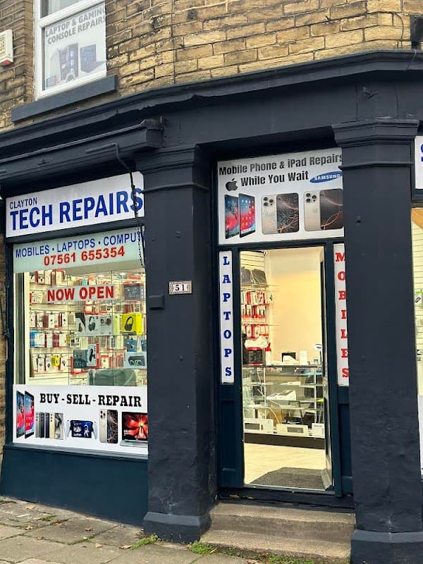 Shopfront of Clayton Tech Repairs featuring signs for mobile, laptop, and iPad repairs, with a welcoming open door.