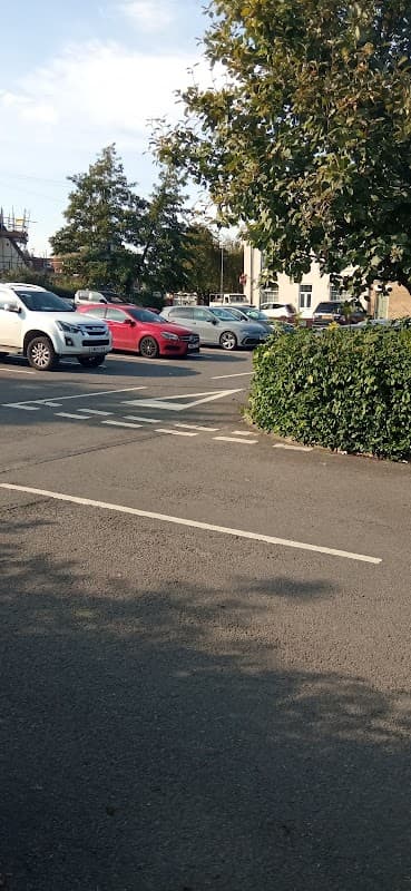 Parking lot at 5 Thorn Rd, Hedon, with several cars and greenery lining the edges.