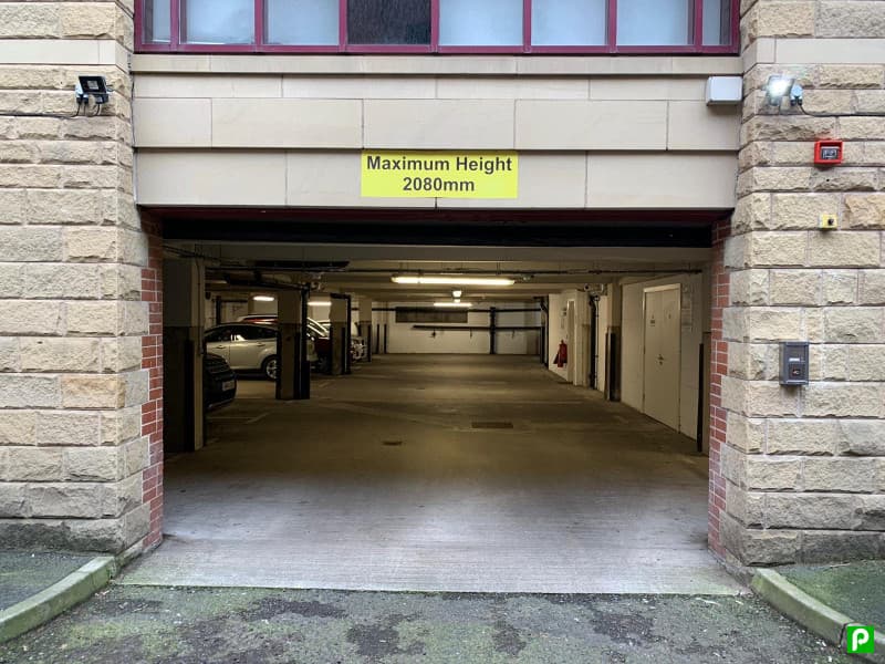 Pay & Display parking entrance with a sign indicating maximum height of 2080mm and empty parking spaces inside.