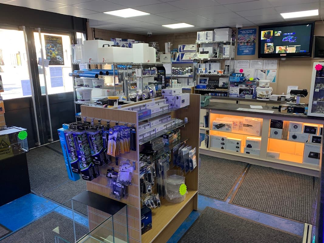 Interior of Fit Filtration pet shop, featuring shelves stocked with various pet supplies and equipment.
