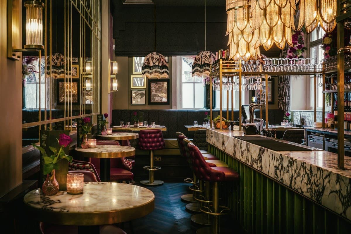 Elegant restaurant interior featuring marble tables, plush seating, and stylish lighting fixtures.