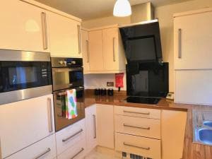 Modern kitchen in Blossomgate apartments, Halifax, featuring sleek cabinets, built-in appliances, and a cozy atmosphere.