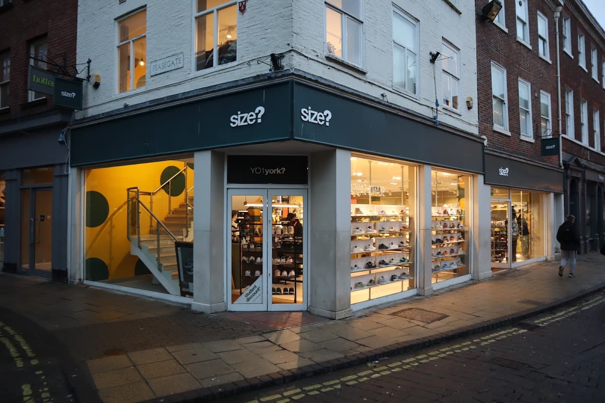 Clothing shop "size?" in Leeds, featuring large windows, a staircase, and displays of footwear.