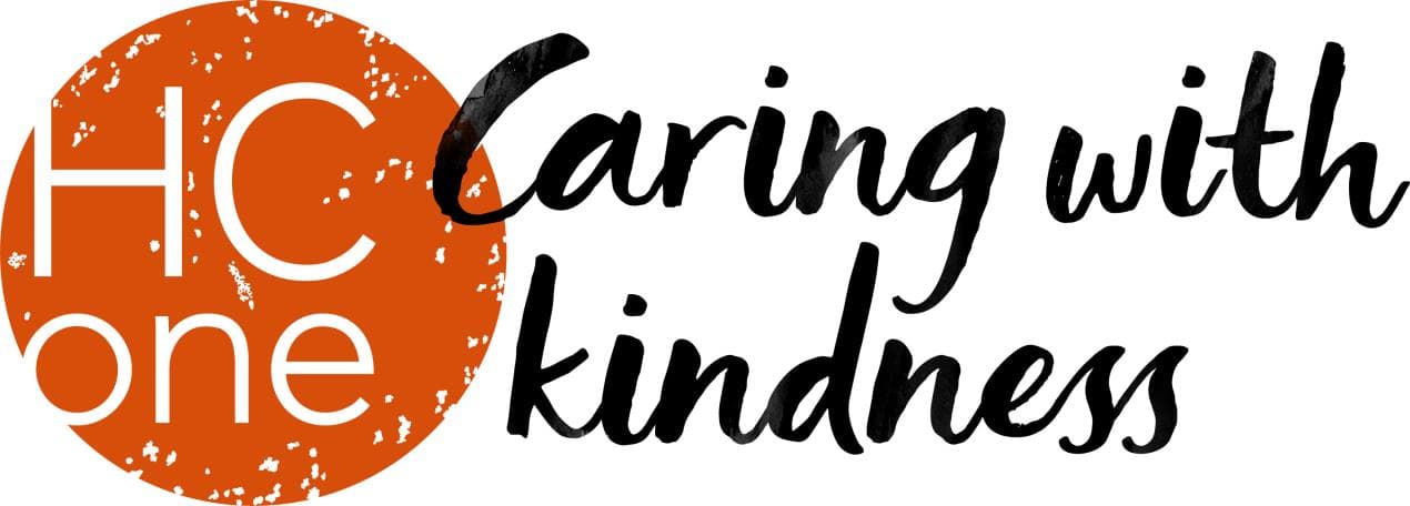 Bright orange and black logo for HC-One, featuring the phrase "Caring with kindness" in a stylish font.