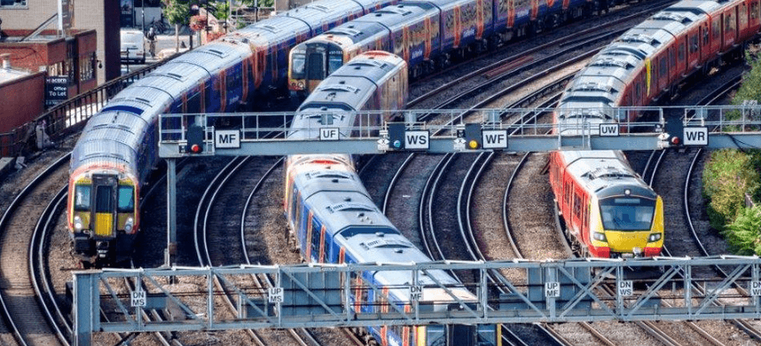 Colorful trains on intersecting tracks at a busy railway junction