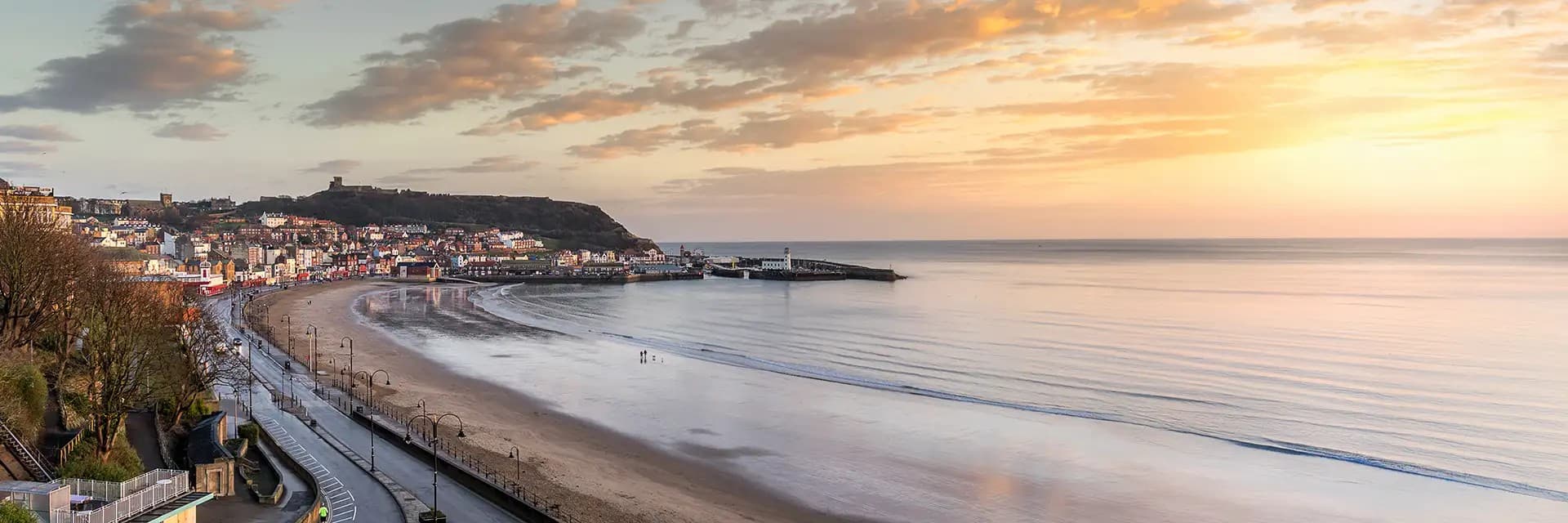 Scarborough beach at sunrise with colorful sky and calm sea