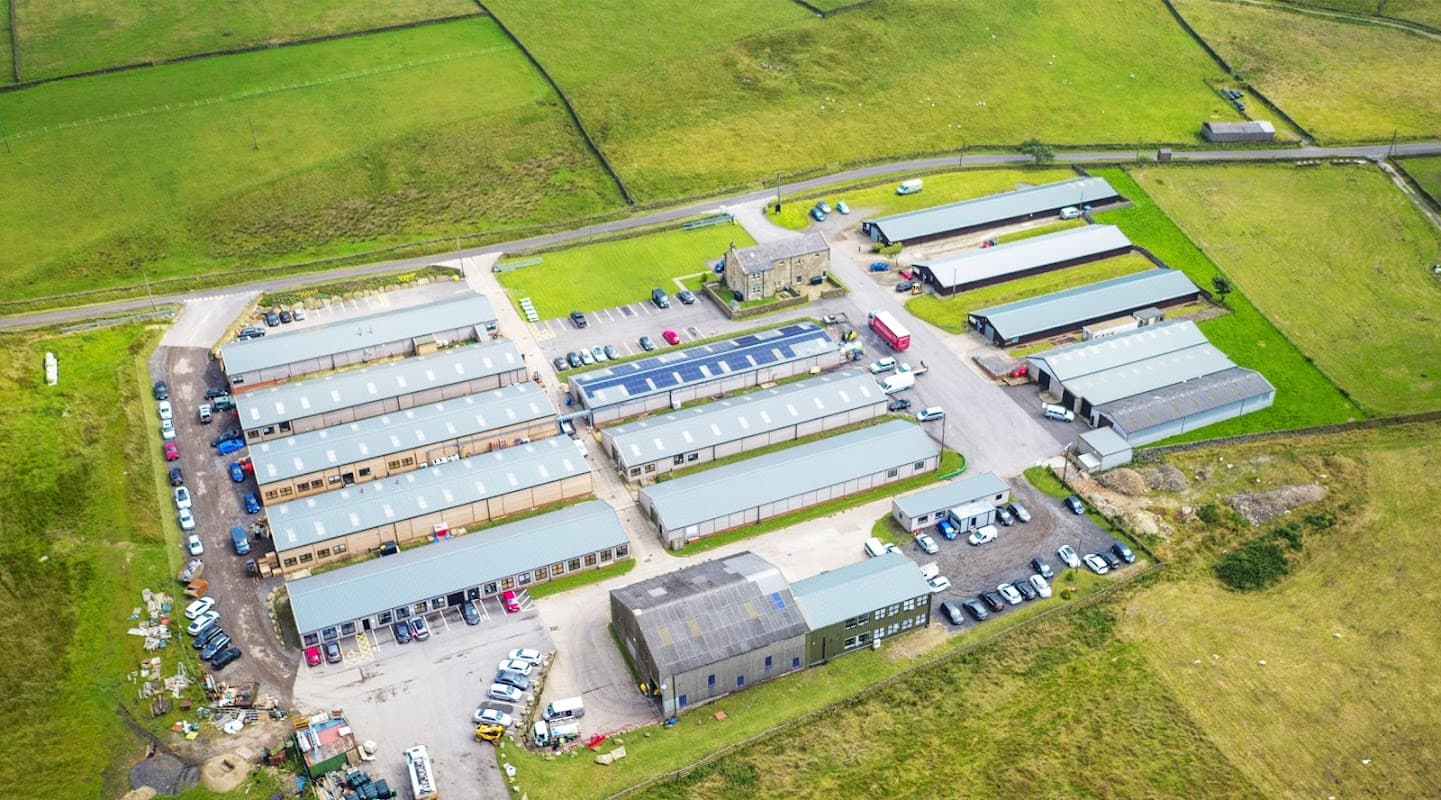 Aerial view of Craggs Country Business Park featuring multiple industrial buildings and vehicles on a green landscape.