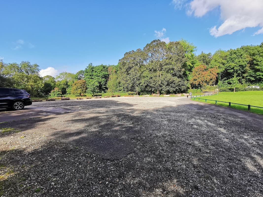 Pay & Display car park at Millhouses Park, surrounded by trees and green space under a clear blue sky.