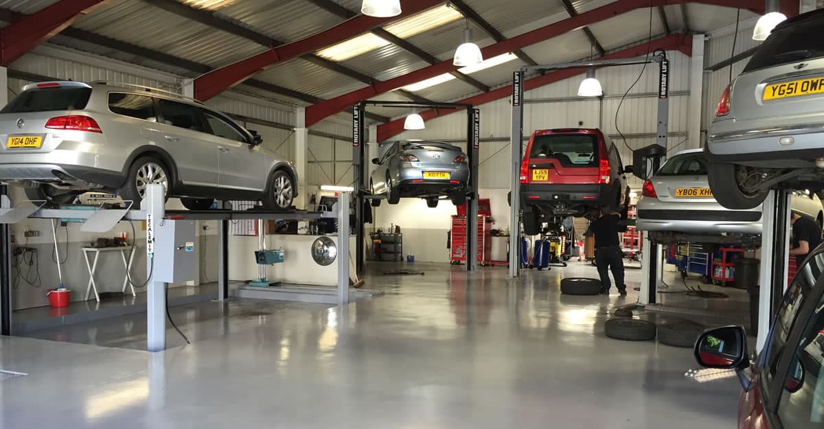 Northowram Garage interior with cars on lifts, tools, and service equipment in a well-lit workshop.