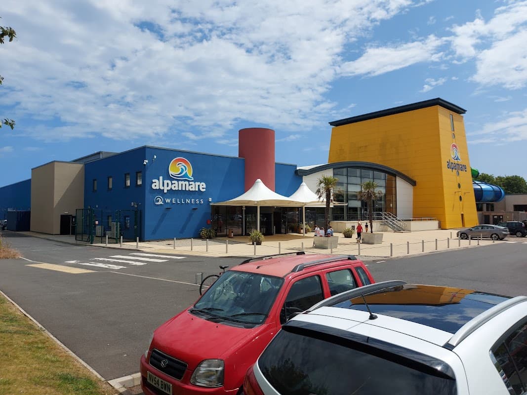 Alpamare Car Park in Scarborough, featuring a colorful building and a Pay & Display area with parked cars.