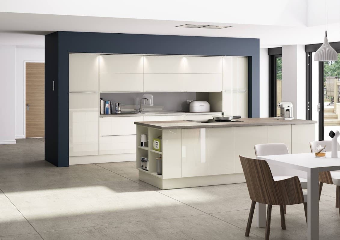 Modern kitchen showroom featuring sleek cabinetry, an island, and contemporary dining area with wooden chairs.