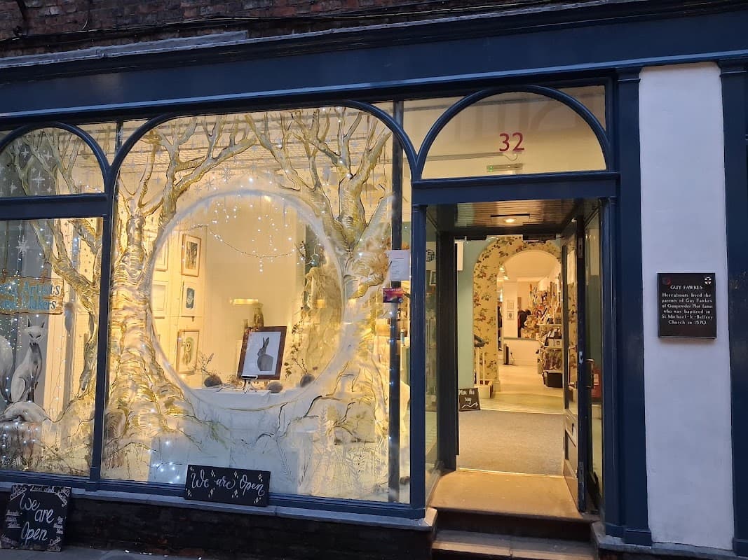 Charming storefront with arched windows, featuring artistic displays and a welcoming entrance in York, Yorkshire.