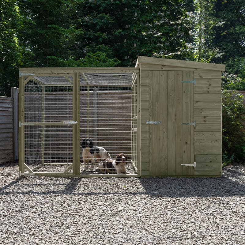 10'1" x 4'6" wooden dog kennel in natural wood finish with a 6ft run, featuring a sturdy construction, wire mesh front, and a sloped roof, set on a gravel surface.