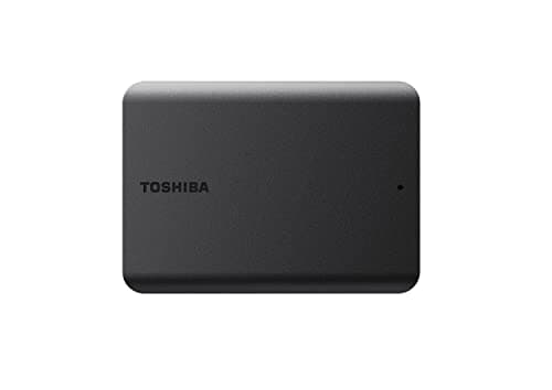 Black Toshiba Canvio Basics 1TB external hard drive with a smooth matte finish, featuring a small LED indicator and the Toshiba logo on the top surface.