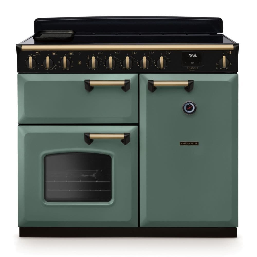 Classic Deluxe 100cm induction range cooker in mineral green with antique brass accents, featuring a sleek black hob, multiple control knobs, and a large oven window.