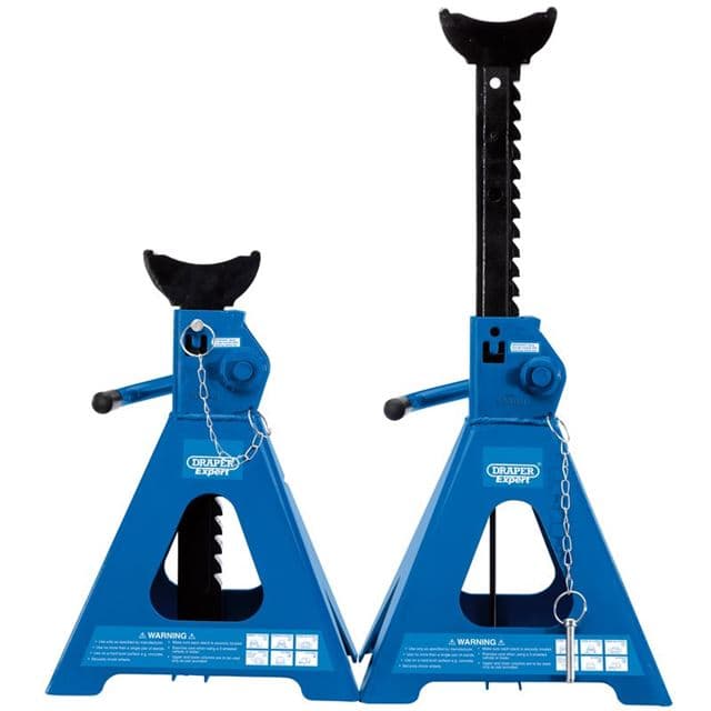 Blue pneumatic rise ratcheting axle stands with a sturdy triangular base, rubber padding on top, and a safety chain, featuring a height-adjustable mechanism for vehicle support.