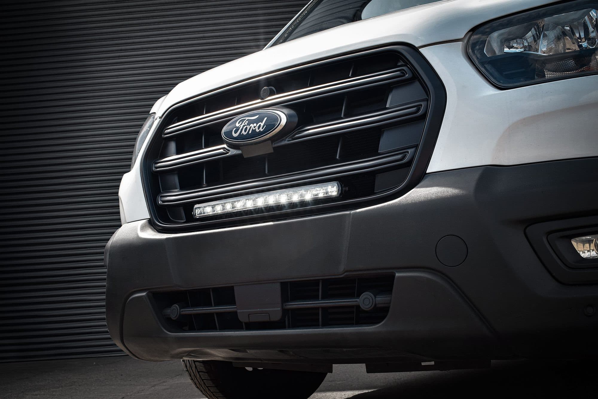 Black grille kit for 2020+ Ford Transit, featuring integrated luminous LED lights, showcasing a sleek design with 8,400 lumens for enhanced visibility.