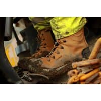 Tan Amblers Safety boot, size 9, with black laces, steel toe, and rugged sole, worn in muddy conditions.