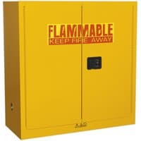 Yellow Sealey flammables storage cabinet with black handle and red warning text "FLAMMABLE KEEP FIRE AWAY" on doors.