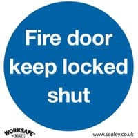 Blue circular vinyl sign with white text "Fire door keep locked shut," Sealey branding at bottom.