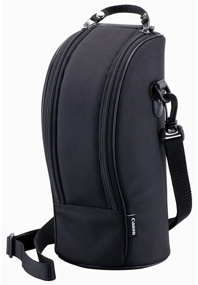Black soft lens case by Canon, featuring a durable exterior, dual zippered compartments, a sturdy handle, and an adjustable shoulder strap for easy carrying.