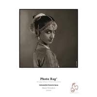 Textured, fine art paper in a soft white tone, featuring a portrait of a woman in traditional attire, with elegant details and a vintage aesthetic, labeled "Photo Rag" by Hahnemühle.