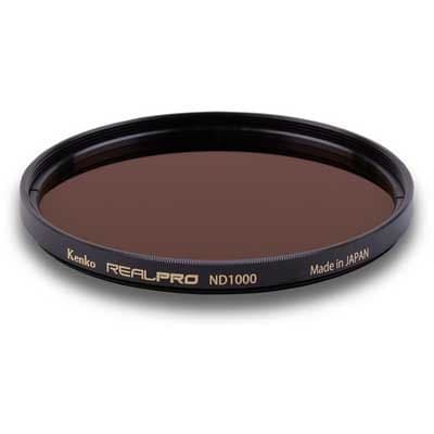 Kenko 67mm REALPRO ND1000 filter with a dark brown glass surface, encased in a black metal frame, featuring gold lettering and "Made in JAPAN" inscription.