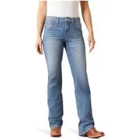 Boot cut jeans for women, light blue wash, mid-rise, classic five-pocket style, worn with brown boots.
