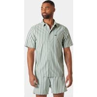 Green Helly Hansen men's short-sleeve shirt with vertical white stripes and button-up front, worn by a model.