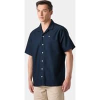 Navy short sleeve button-up shirt with collar and chest pocket, worn by a male model, by Helly Hansen.