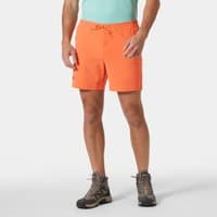 Orange Helly Hansen men's shorts with drawstring waist, 6-inch length, worn by model in hiking boots.