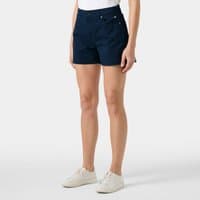 Navy Helly Hansen women's shorts with front pockets, belt loops, and button closure, worn by model with white sneakers.