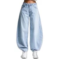 High-waisted light blue balloon jeans with wide legs and a relaxed fit, worn with white sneakers.