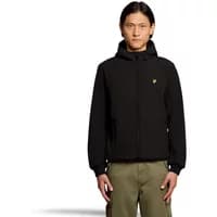 Black Lyle & Scott jacket with fleece lining, hood, and yellow logo on chest, worn by model with hands in pockets.