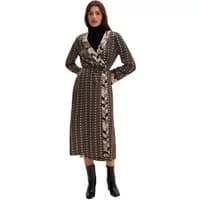 Brown long wrap dress with belt, floral trim, and polka dot pattern, worn by a woman with black boots.