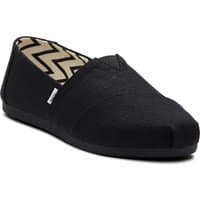 Black TOMS Alpargata cotton women's trainers with slip-on design and zigzag pattern lining.