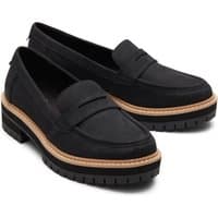 Black TOMS Women's Cara Loafer with chunky sole, tan trim, and penny strap detail.