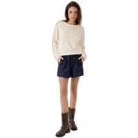 Cream Artlove Anisae sweater with long sleeves and relaxed fit, paired with navy shorts and brown boots.