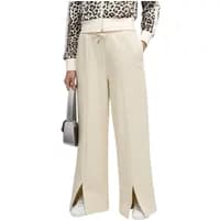 Beige Puma women’s casual trousers with wide legs, front slits, and drawstring waist.