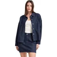 Oversized pinstripe denim jacket, dark blue with button front, worn by model over white top and matching skirt.