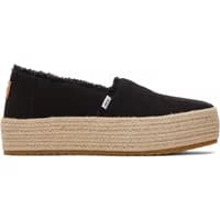 Black women’s platform espadrilles by TOMS with woven jute sole and frayed edges.