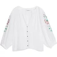 White Desigual Roman blouse with floral embroidery on sleeves and button-down front.